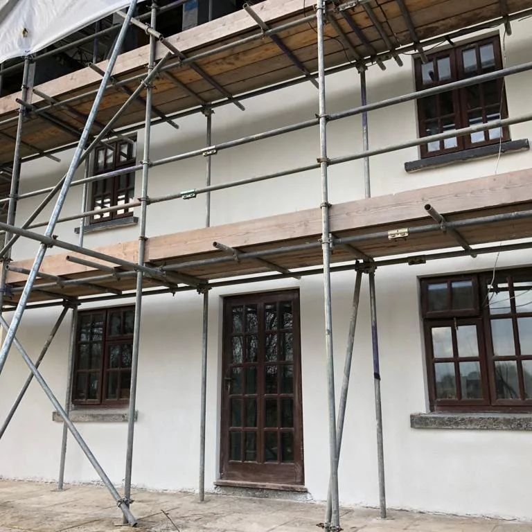 Fresh render on a scaffolded house front