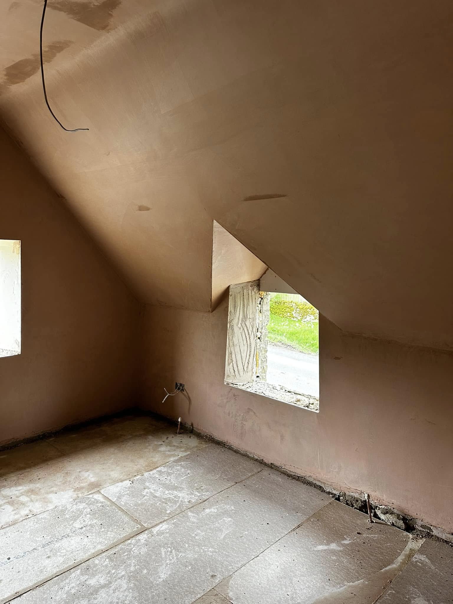 Loft room plastered around a dormer window