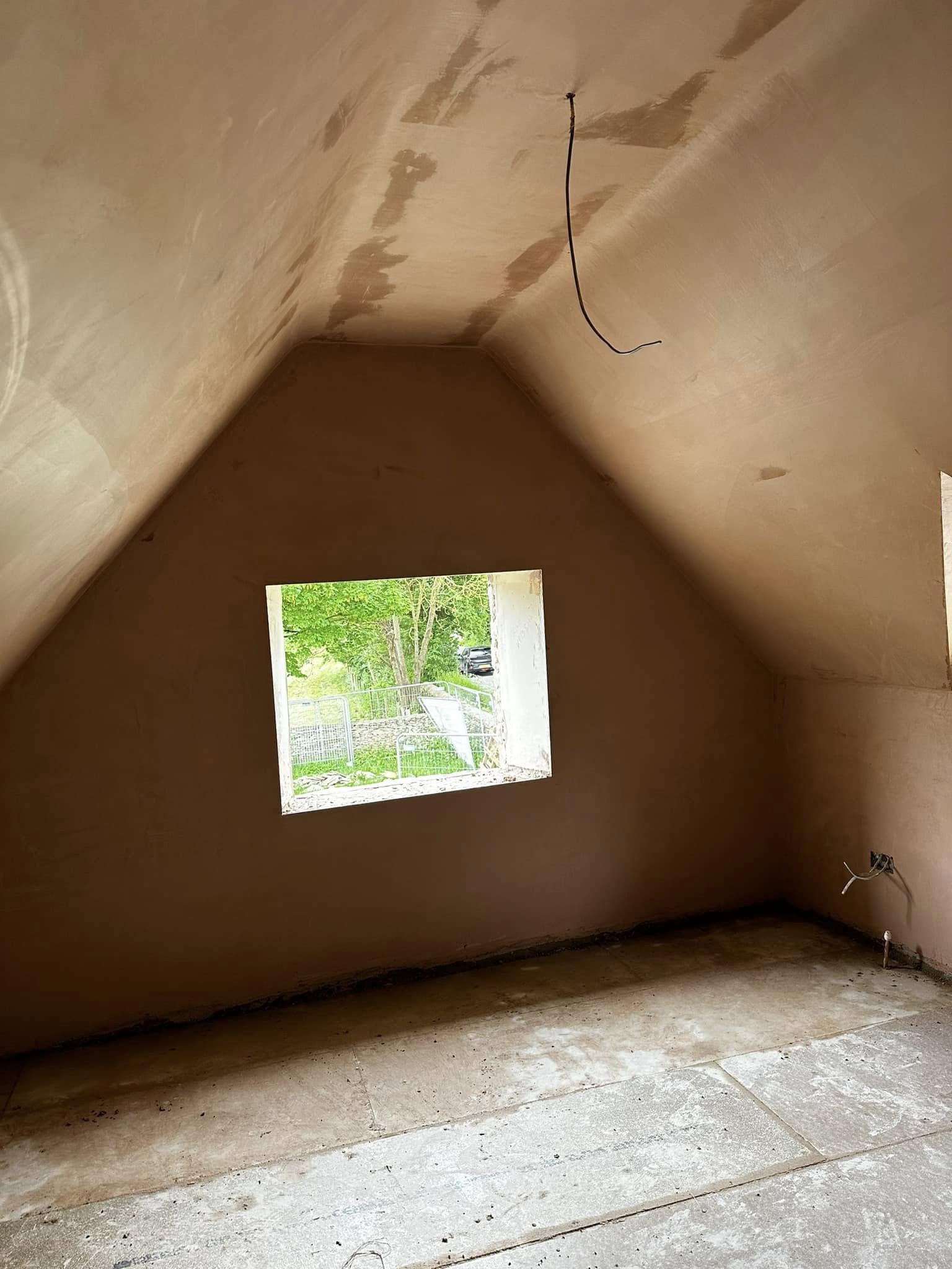 Plastered loft gable with a window opening