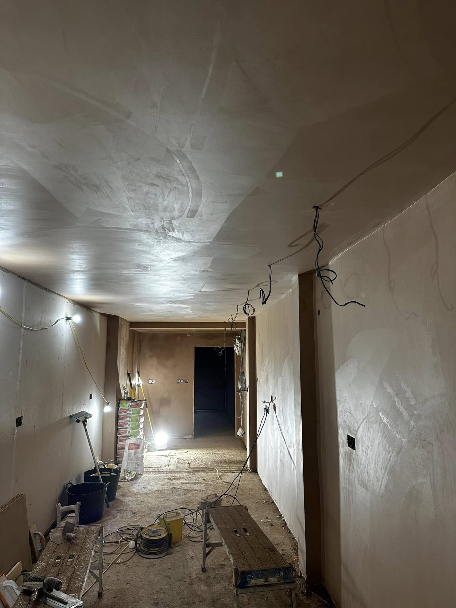 Freshly skimmed hallway under work lights