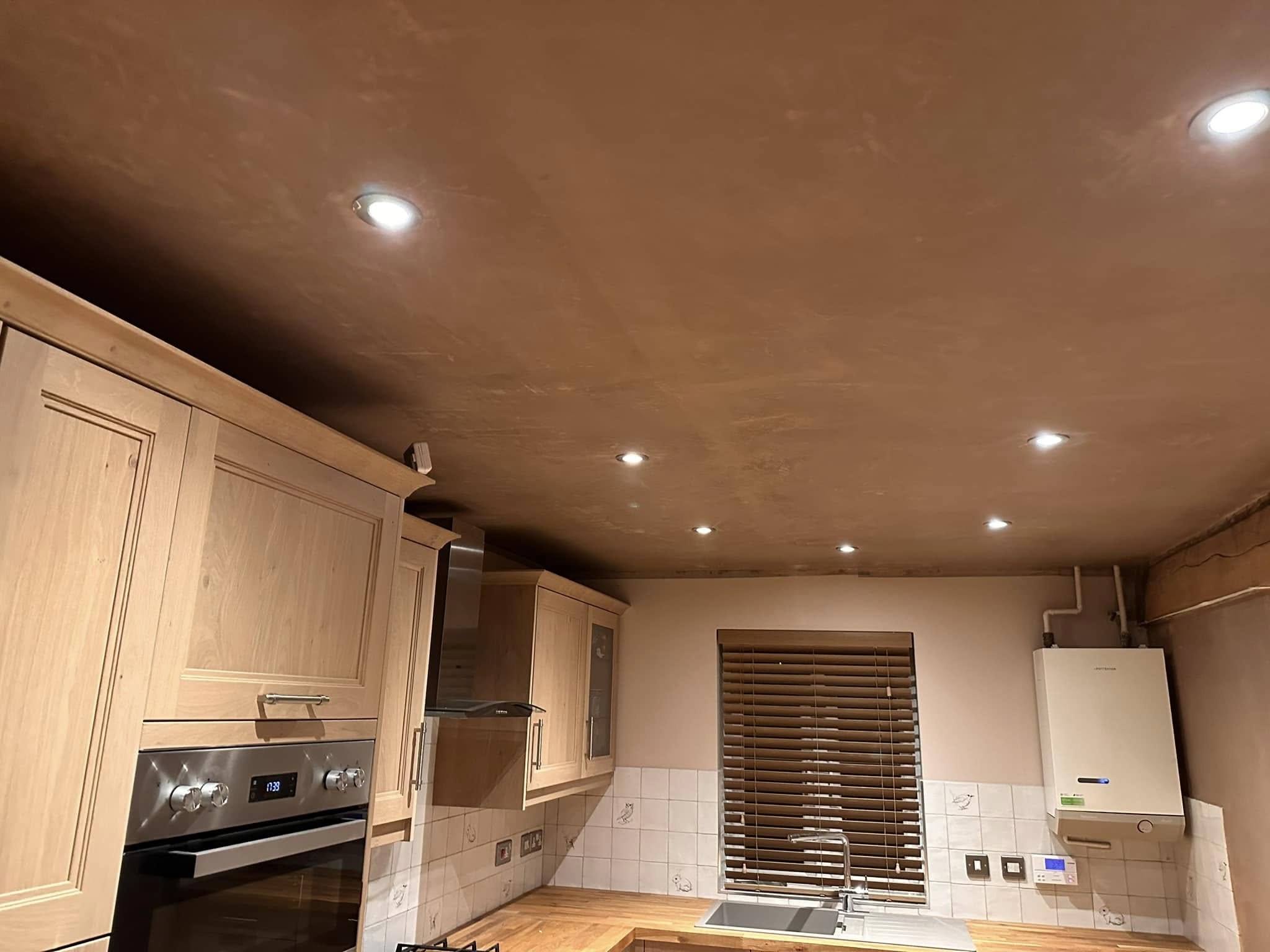 Fresh plaster ceiling over a fitted kitchen