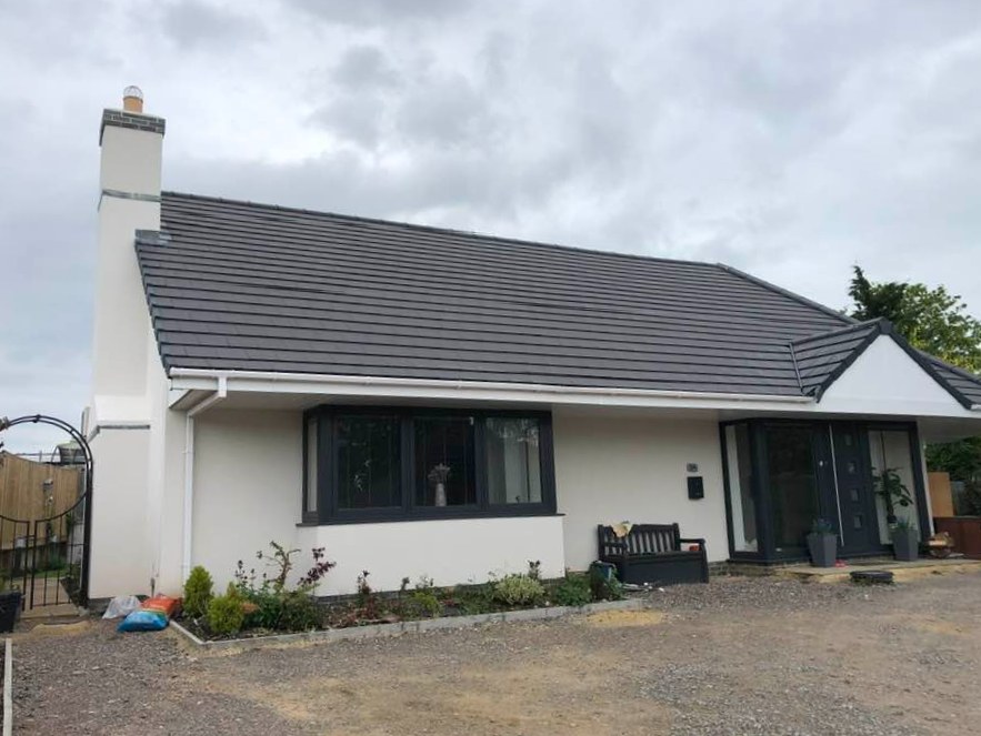 Rendered bungalow with a new grey roof