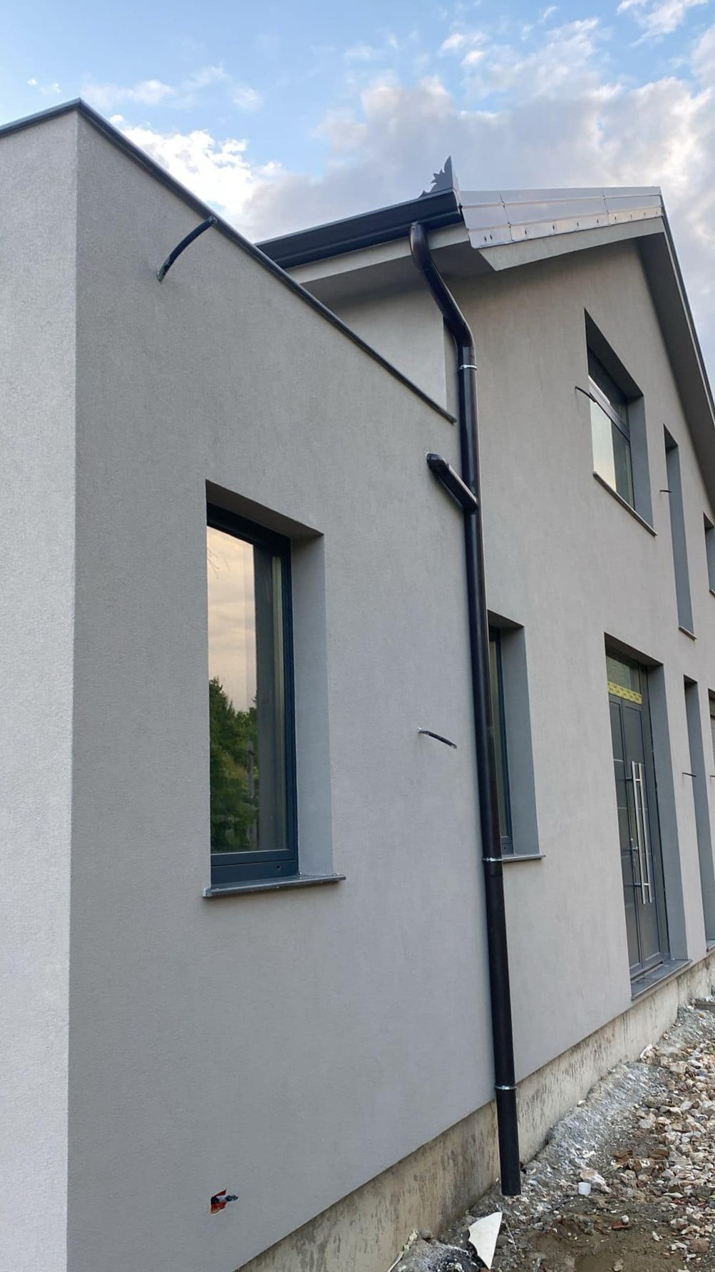Smooth grey render on a tall new build wall