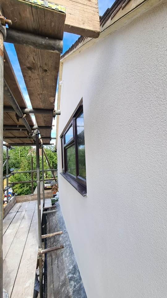 Fresh white render seen from the scaffold boards