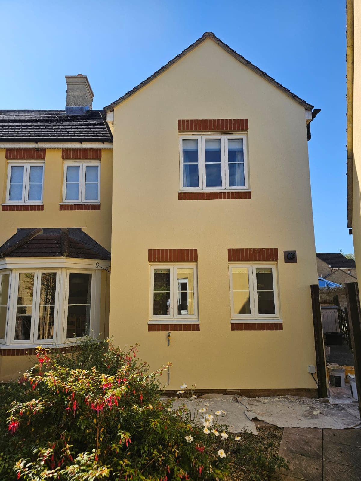 Cream rendered gable end of a detached house