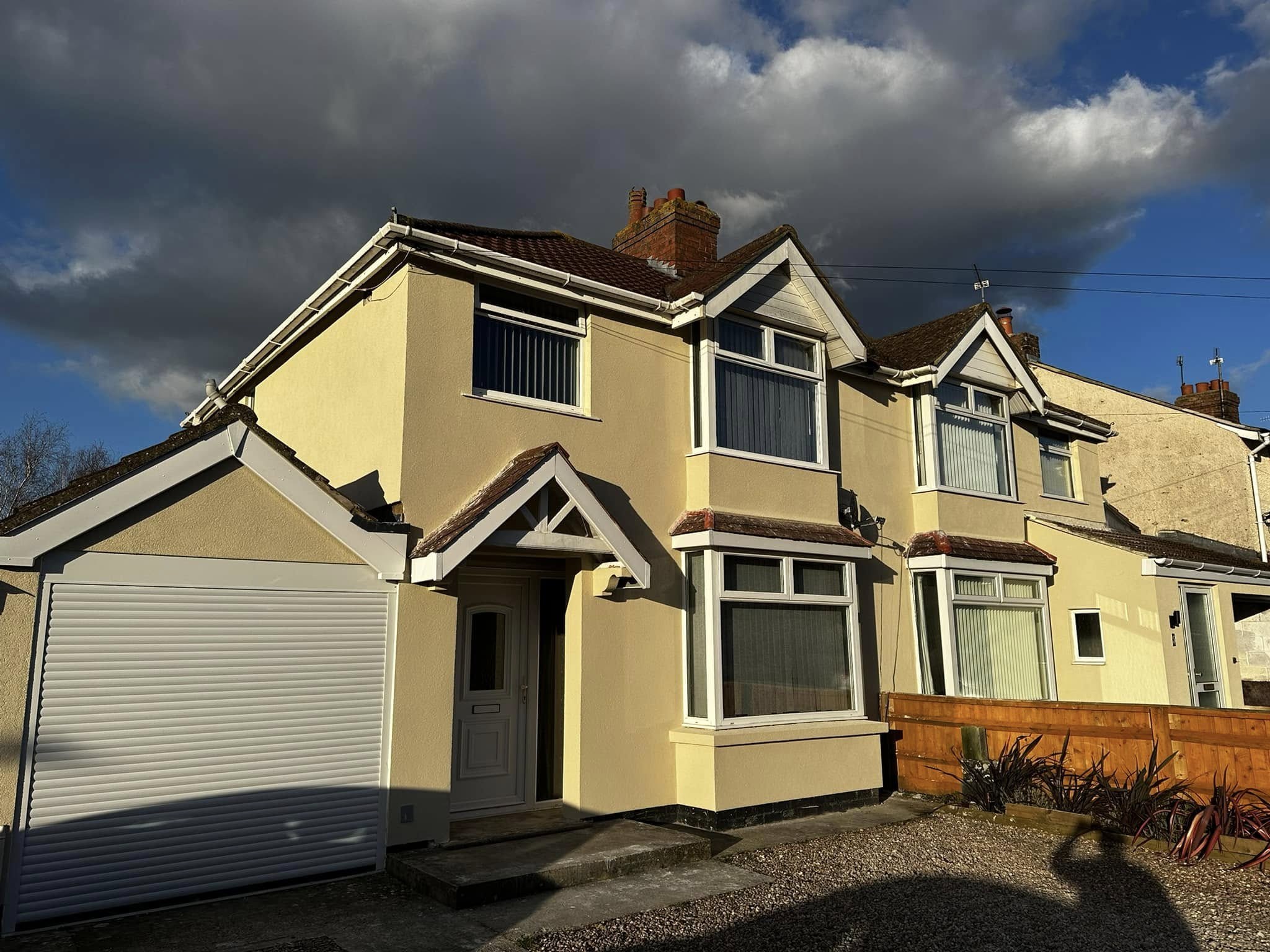 A cream rendered semi-detached house front finished by our team